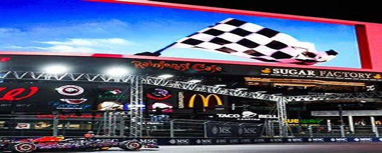 Aerial view of Formula 1 cars racing on the Las Vegas Strip during the Grand Prix at night.